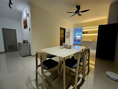 a kitchen with a table and chairs and a ceiling fan at The Cozy 88 ipoh in Ipoh