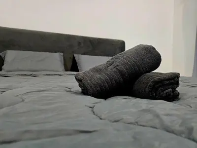 a bed with two coils of gray yarn on it at The Cozy 88 ipoh in Ipoh