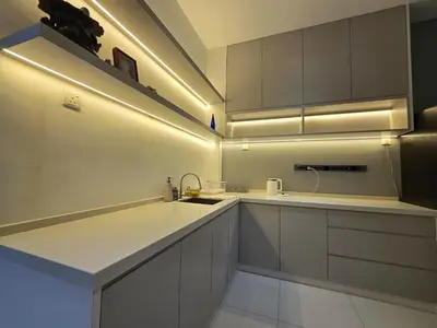 a kitchen with white cabinets and a sink at The Cozy 88 ipoh in Ipoh