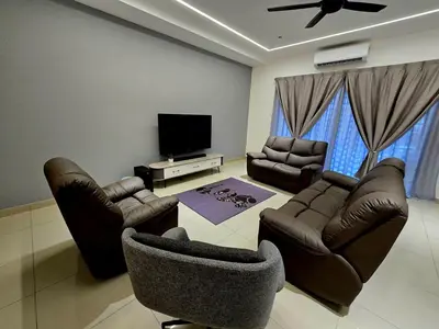 a living room with leather furniture and a flat screen tv at The Cozy 88 ipoh & in Ipoh