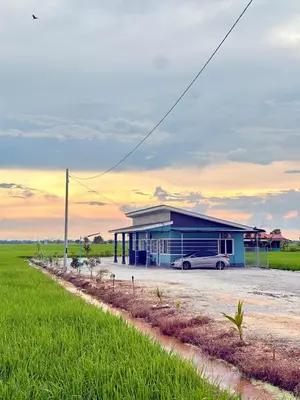 a blue building with a car parked in front of it at Rumah Teduh in Gua Sai