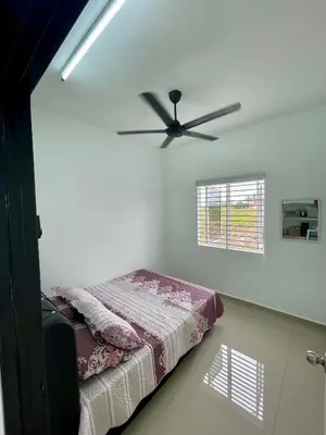 a bedroom with a bed and a ceiling fan at Rumah Teduh in Gua Sai