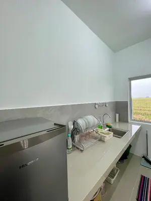 a kitchen counter with a sink and a window at Rumah Teduh in Gua Sai