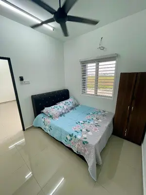 a bedroom with a bed and a ceiling fan at Rumah Teduh in Gua Sai