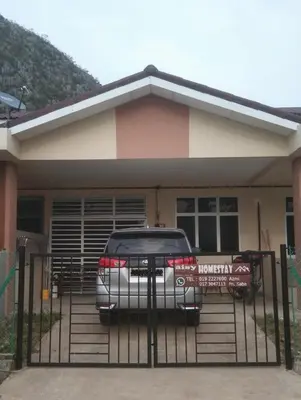a car parked in front of a house at Small house surrounding with nature in Gua Musang
