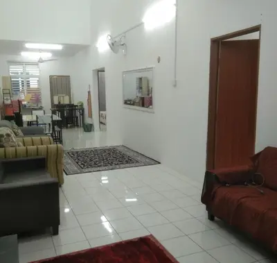 a living room with a couch and a table at Small house surrounding with nature in Gua Musang