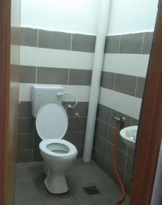 a bathroom with a toilet and a sink at Small house surrounding with nature in Gua Musang