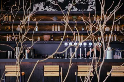 a bar with chairs and a shelf with bottles at Shō Hotel Penang in George Town