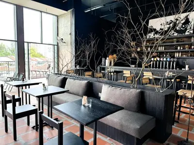 a restaurant with tables and chairs and a couch at Shō Hotel Penang in George Town