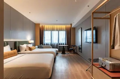 a hotel room with two beds and a couch at Shō Hotel Penang in George Town