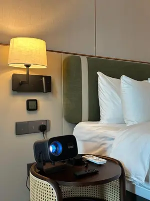 a room with a bed and a table with a lamp at Shō Hotel Penang in George Town