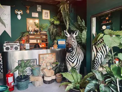 a statue of a zebra standing in a room with plants at Very Hotel in George Town