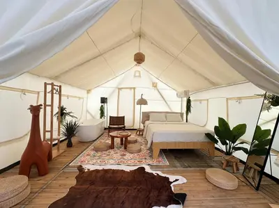 a tent with a bed and a table at Very Hotel in George Town