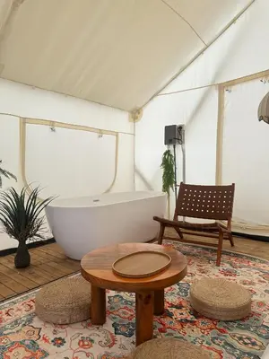 a bathroom with a tub and a table in a tent at Very Hotel in George Town