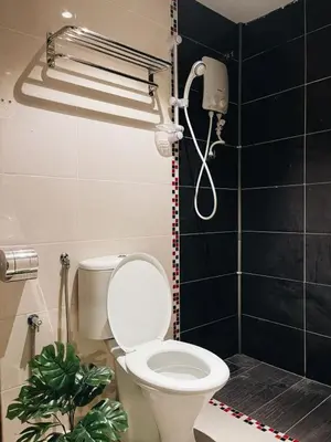 a bathroom with a toilet and a shower at Very Hotel in George Town
