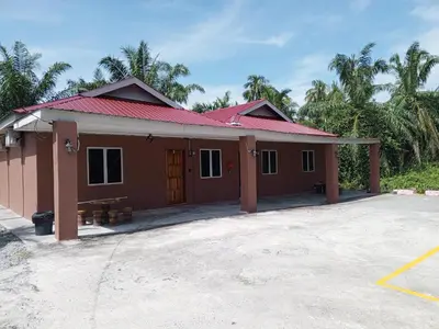 a small house with a red roof at Dhania Homestay in Gua Sai