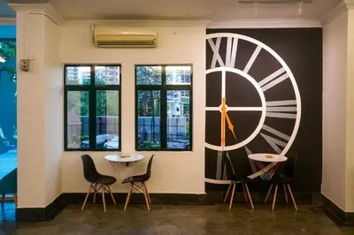 a wall with a large clock on the wall at Stallions Suite in Jelutong