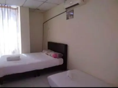 a small room with a bed and a window at Hotel Tropicanna Pulai Point in Ipoh