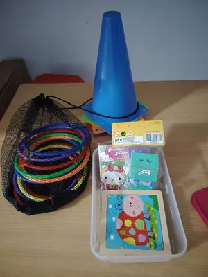 a table with a plastic container and a coil of yarn and a blue cone at Happy Home in Kuala Kubu Baharu