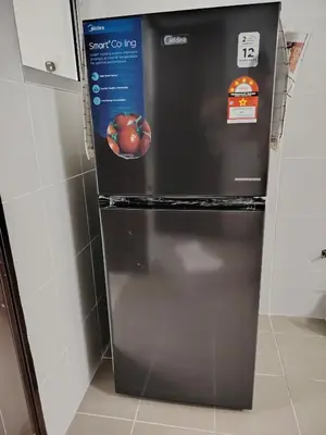 a refrigerator with an apple on it in a kitchen at Happy Home in Kuala Kubu Baharu