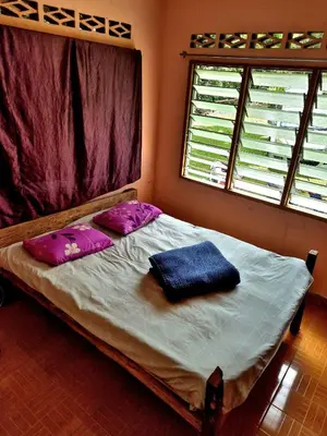 a bed in a room with two pillows on it at Devalley Basecamp in Kampong Ulu Dong