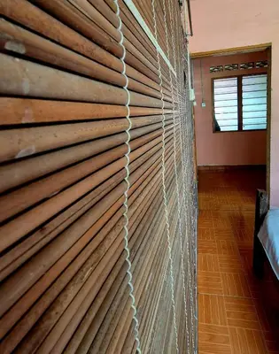 a wooden sliding door in a room at Devalley Basecamp in Kampong Ulu Dong