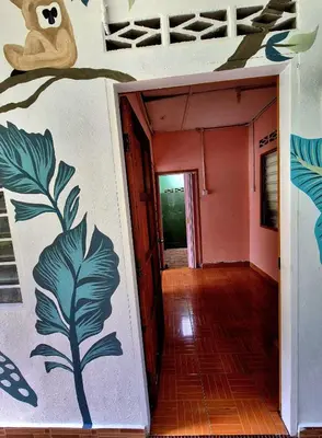 an empty hallway with a painting on the wall at Devalley Basecamp in Kampong Ulu Dong