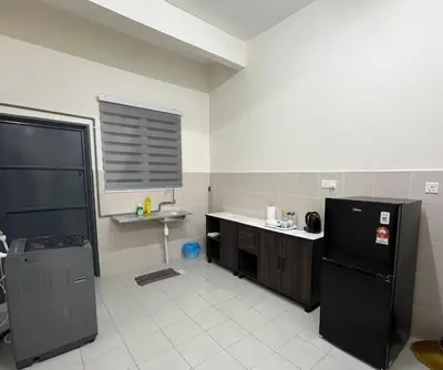 a kitchen with a black refrigerator and a sink at TemuHomestay in Kamunting