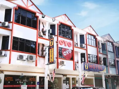 a large white building with red trim at Super OYO 635 Seven Days Hotel in Kampong Sempalit Hilir