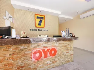 a restaurant with aoops sign on a brick wall at Super OYO 635 Seven Days Hotel in Kampong Sempalit Hilir