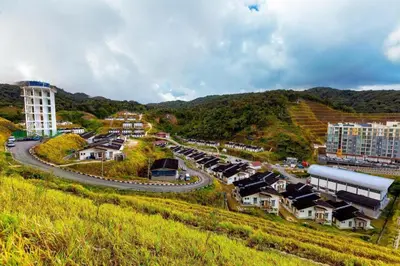 a small town on a hill with a road and buildings at SPOT ON 89751 Bed Station Guest House in Tanah Rata