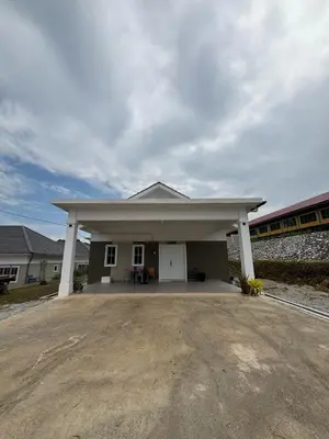a large white building with a train in the background at D'Laman Homestay in Slim River