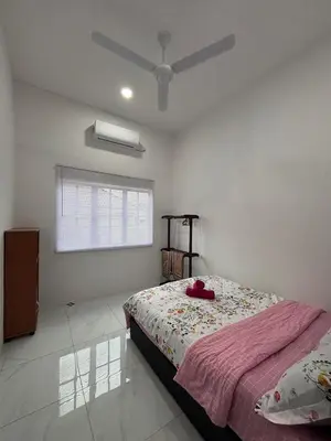 a bedroom with a bed and a ceiling fan at D'Laman Homestay in Slim River