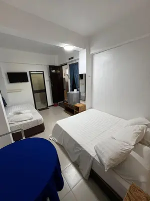 a bedroom with two beds and a blue table at Nipah Bay Villa in Pangkor