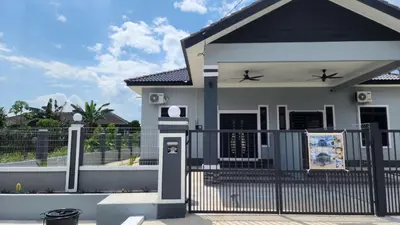 a small house with a gate and a fence at Yash Cottage Taiping Homestay in Taiping