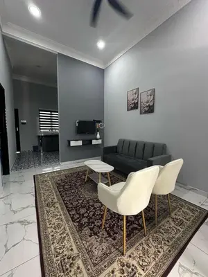 a living room with a couch and chairs and a rug at Yash Cottage Taiping Homestay in Taiping