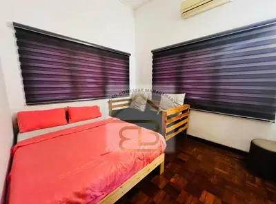 a bedroom with a bed and a desk and two windows at 188 Private Pool Mansion Ipoh KTV BBQ 30Pax in Ipoh