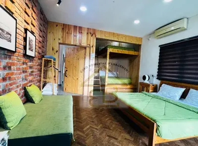 a bedroom with two beds and a brick wall at 188 Private Pool Mansion Ipoh KTV BBQ 30Pax in Ipoh