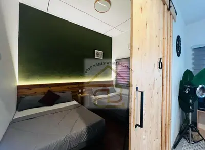 a bedroom with a bed with a green wall at 188 Private Pool Mansion Ipoh KTV BBQ 30Pax in Ipoh