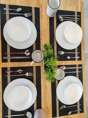 an overhead view of a table with white plates and silverware at Urban Suites, 4 Plus 2 Pax, 2 Bedrooms Apartment in Jelutong
