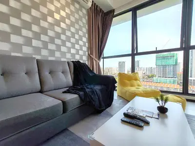 a living room with a couch and a table at Urban Suites, 4 Plus 2 Pax, 2 Bedrooms Apartment in Jelutong