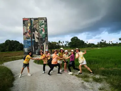 a group of girls dancing on a dirt road at Quadruple Traditional Wooden GuestHouse in Balik Pulau