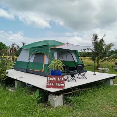 a tent on a board in a field at Quadruple Traditional Wooden GuestHouse in Balik Pulau