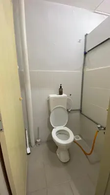 a bathroom with a white toilet in a stall at Sofea Homestay Tasek Gelugor in Kampong Kubang Menderong