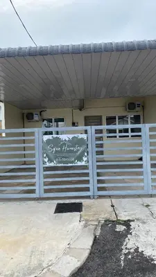 a house with a fence with a sign on it at Sofea Homestay Tasek Gelugor in Kampong Kubang Menderong