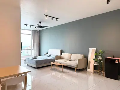 a living room with a couch and a table at Perffect JB view Paradigm UTM in Gua Sai
