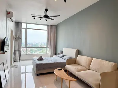a living room with a couch and a bed at Perffect JB view Paradigm UTM in Gua Sai