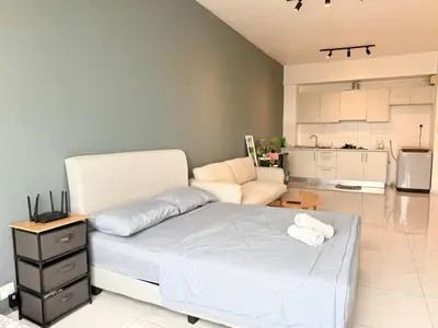 a bedroom with a bed and a living room at Perffect JB view Paradigm UTM in Gua Sai