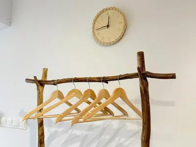 a clock hanging on a wall next to a wooden rack at Cozy Studio I Riveria City I 1km to KL Sentral in Gua Sai