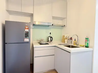 a small kitchen with a refrigerator and a sink at Cozy Studio I Riveria City I 1km to KL Sentral in Gua Sai
